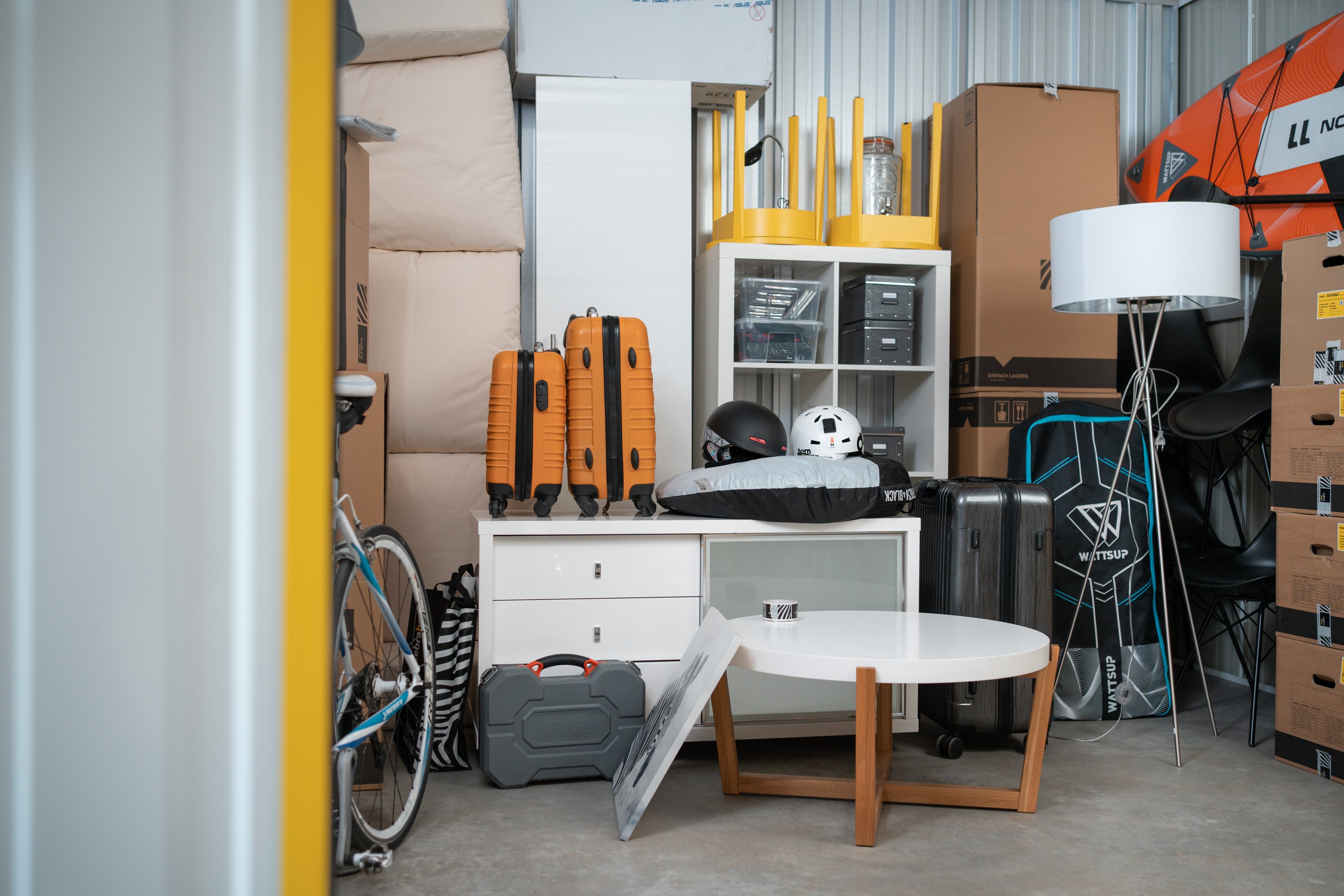 A storage unit at Zebrabox filled with household items, sports equipment and moving boxes.