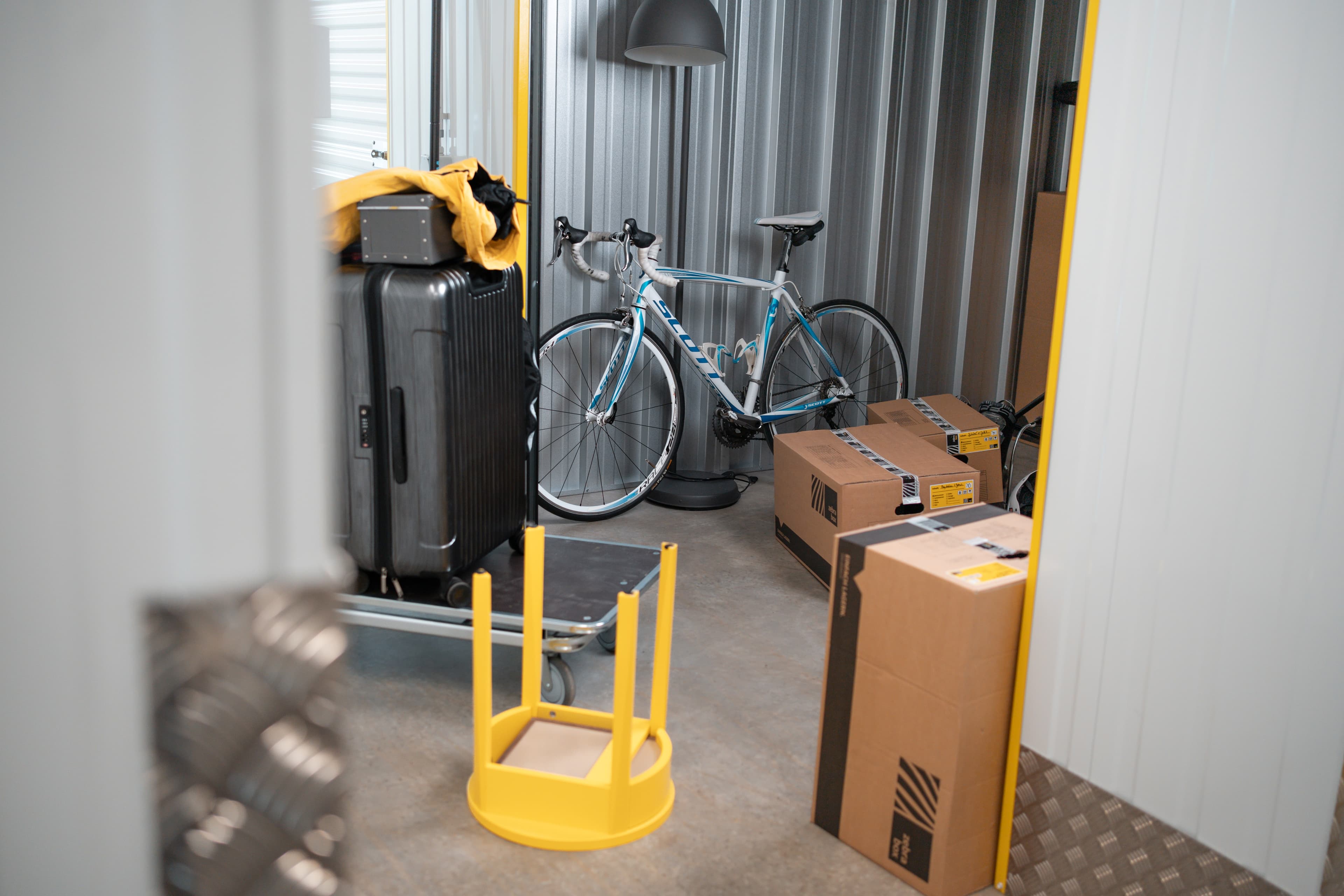 A storage unit at Zebrabox filled with household items, sports equipment and moving boxes.